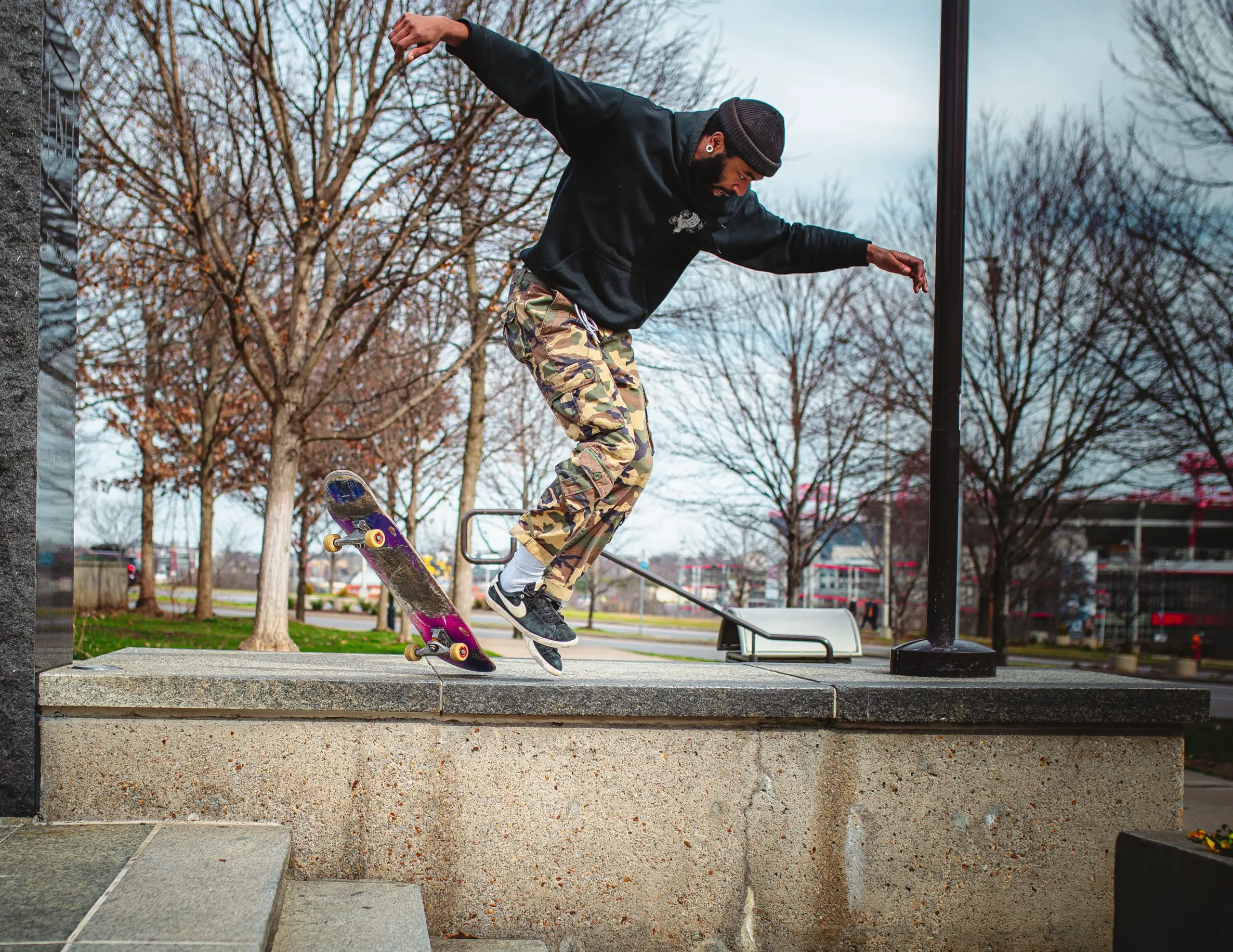 Image of a male skateboarder doing a freestyle skateboard trick on a ramp. Source: unsplash