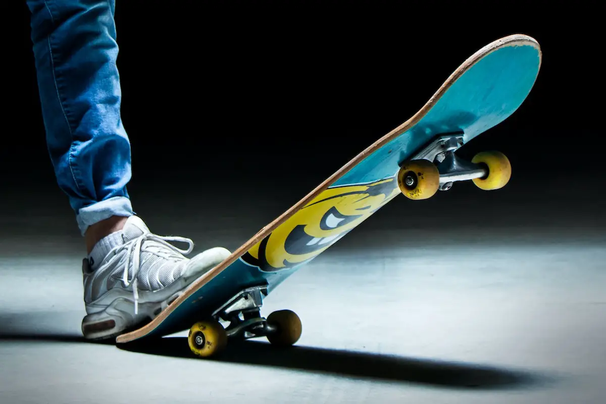 Image of a man with one foot on a skateboard. Source: levi frey, unsplash