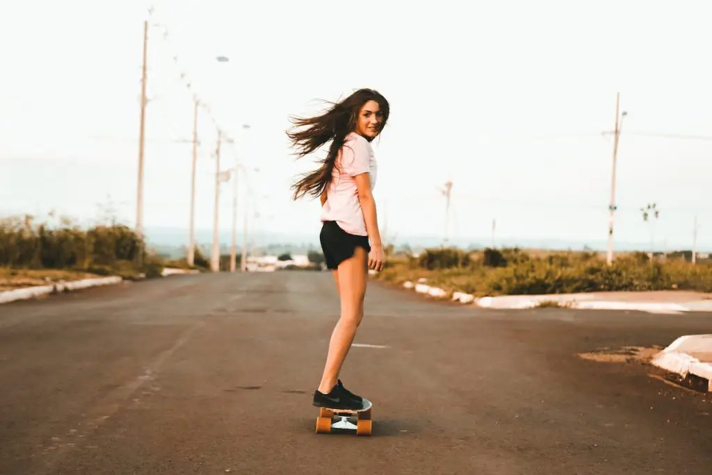 Image of a woman skateboarding on the road. Source: vidal balielo jr, pexels