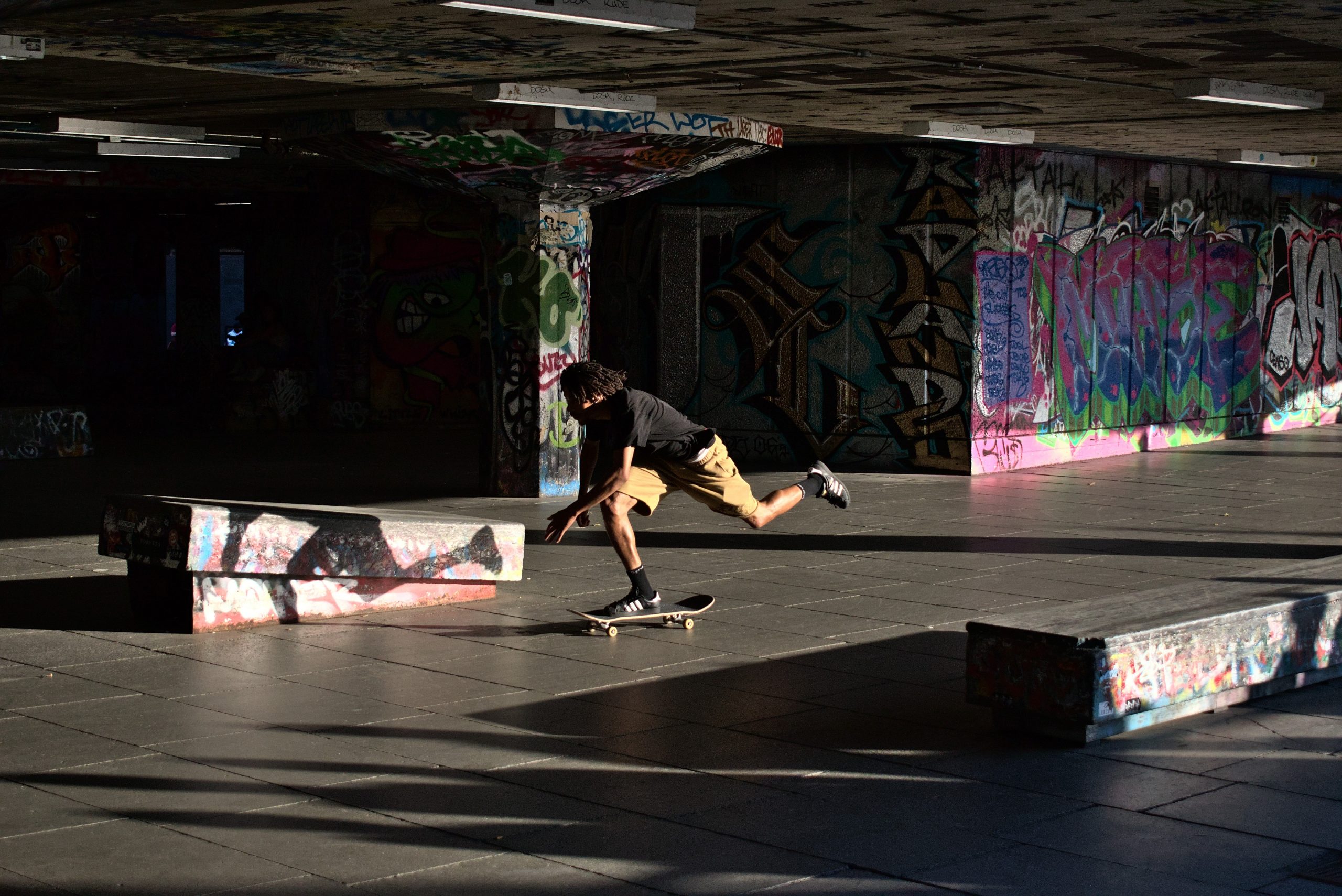 Image of a man in black shirt skateboarding in a skate park. Source: stefano bucciarelli, unsplash