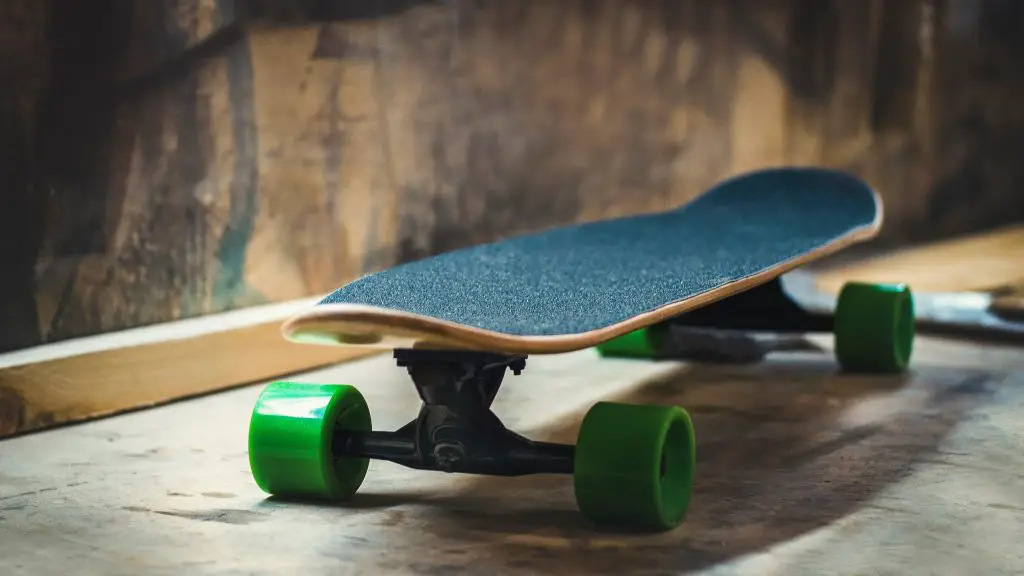 Image of a skateboard with black deck and green wheels. Source: the nigmatic ,unsplash
