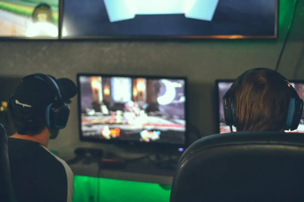 Image of two men playing video games. Source: alex haney, unsplash