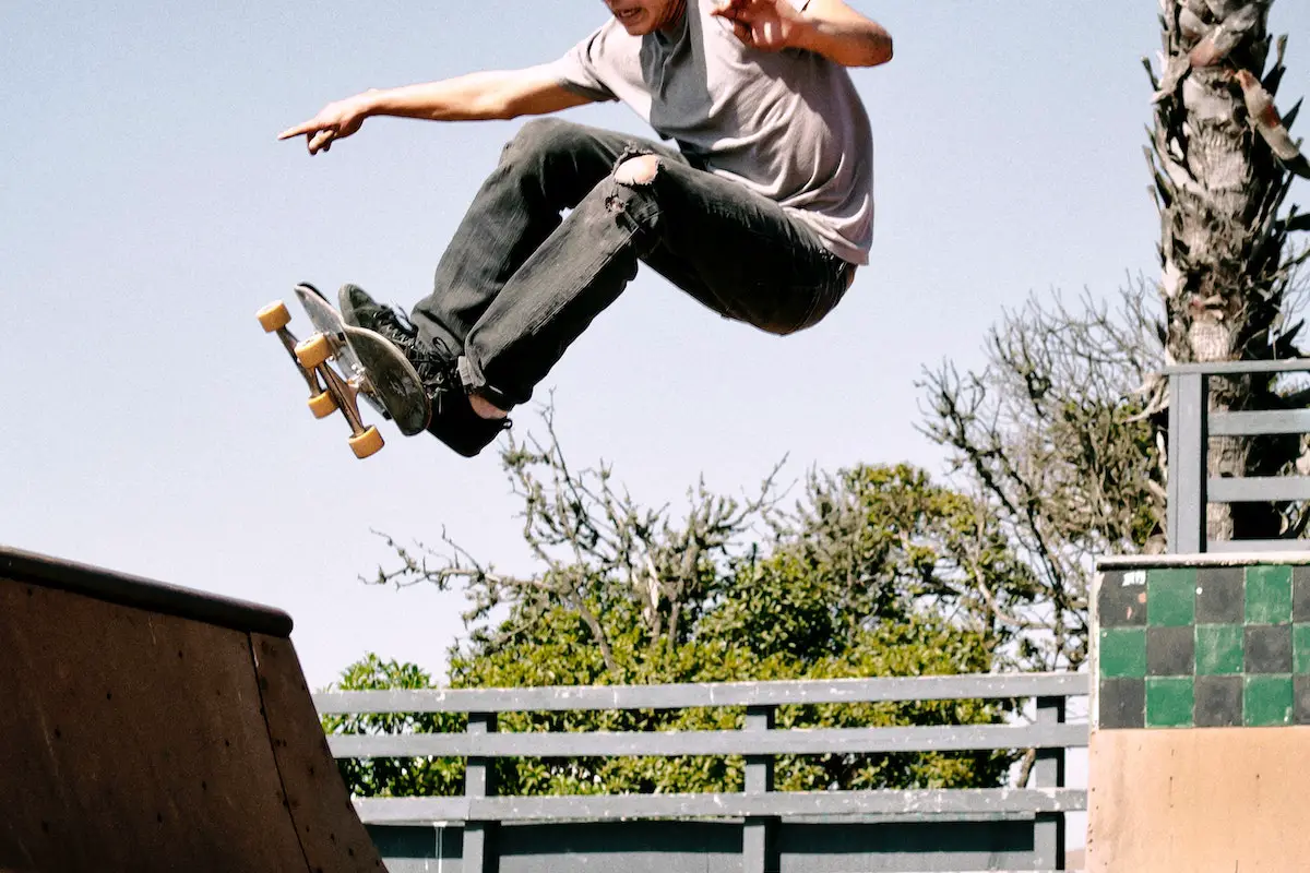 Image of a skateboarder doing an alley oop on a vert ramp. Source: tim mossholder, pexels