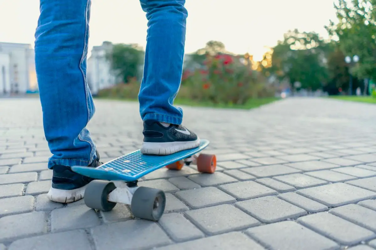 Image of a man stepping on a penny board. Source: pixabay