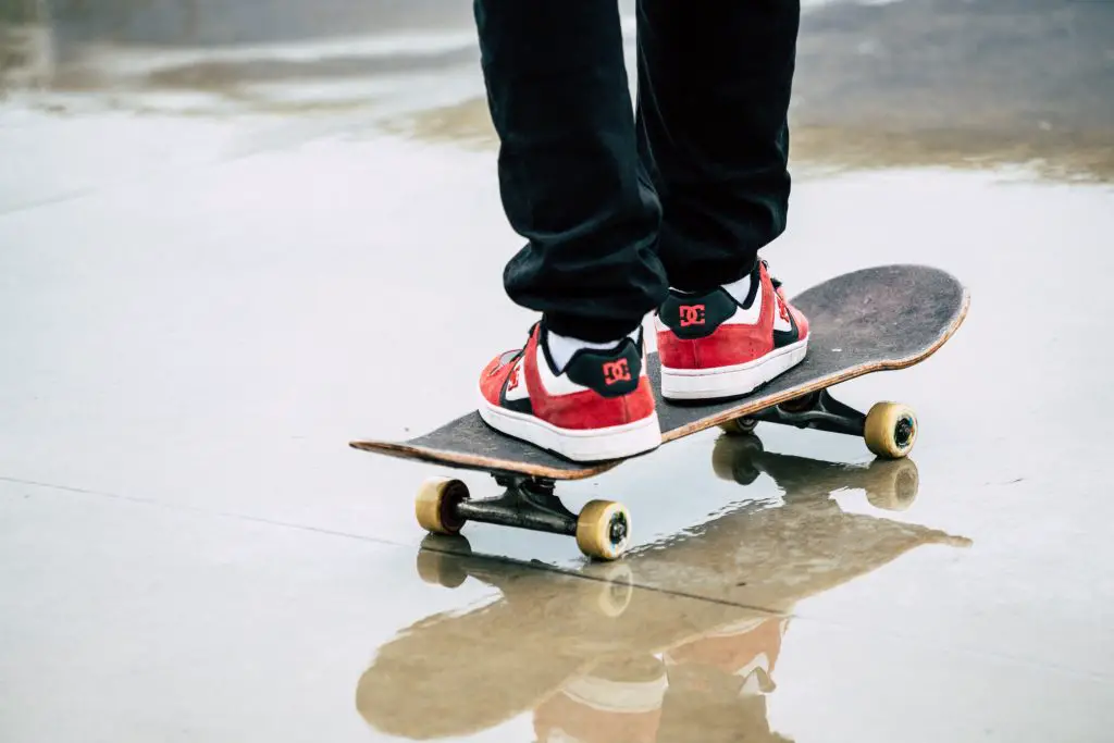 Image of a skateboarder using a skateboard on a wet floor. Source: unsplash