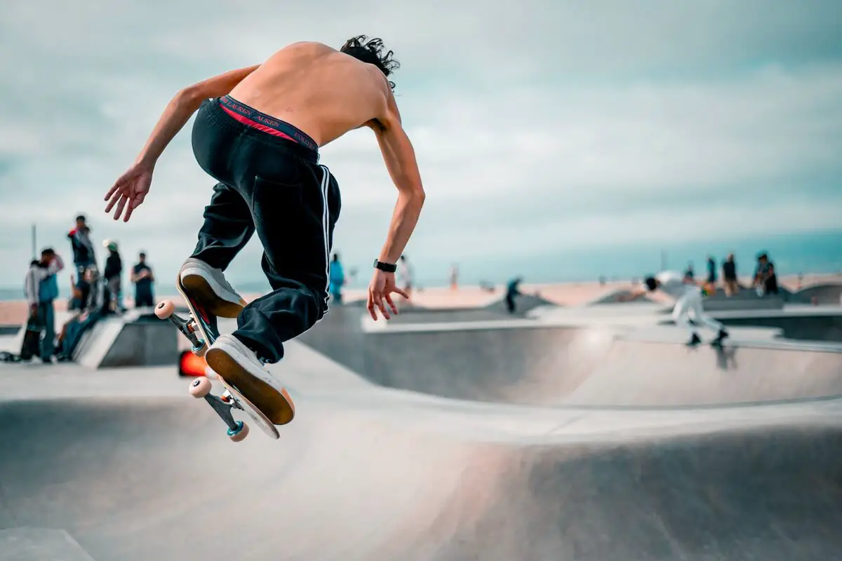 Image of a skater doing a trick on a skateboard ramp. Source: unsplash