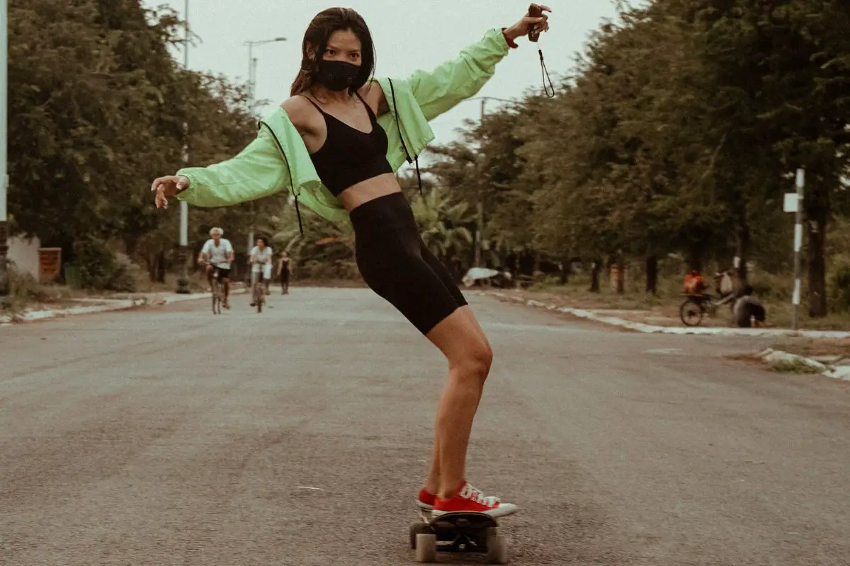Image of a woman skateboarding down the road. Source: tony pham, unsplash