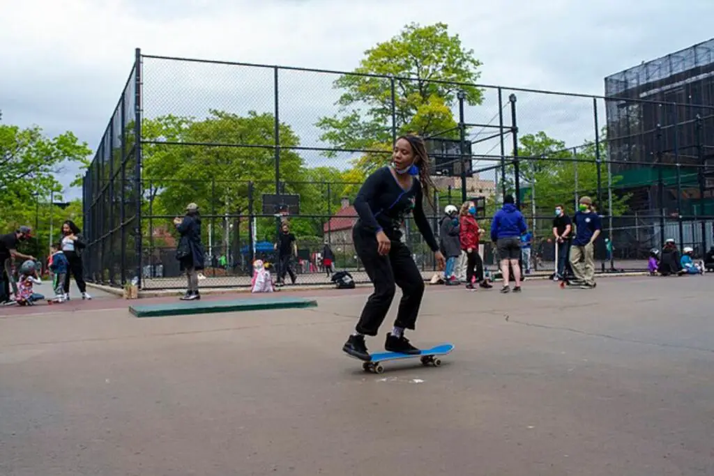 Image of a female skateboarder skating in the park.