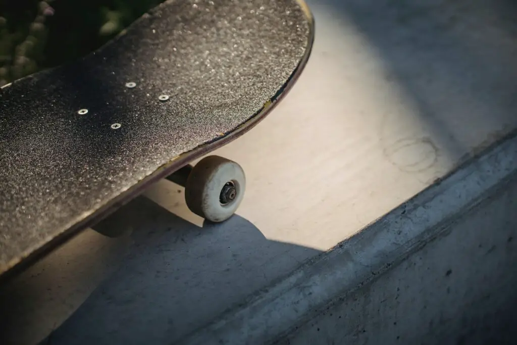 Image of a black skateboard's nose on a concrete surface. Source: pexels