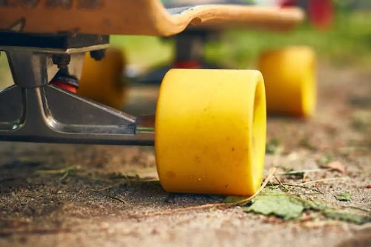 Image of a skateboard's yellow wheels and trucks.
