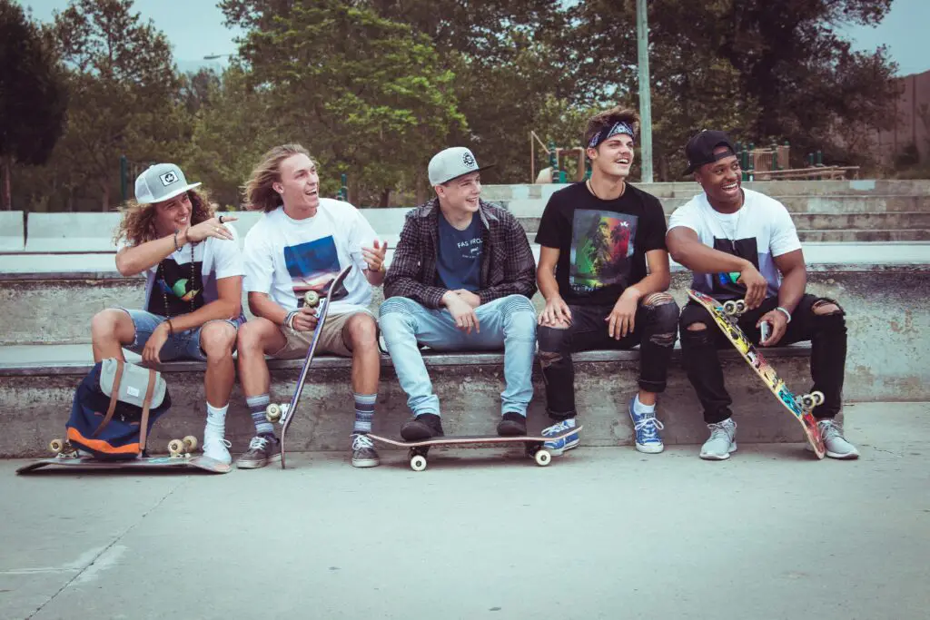 Image of a group of skateboarders in a park.