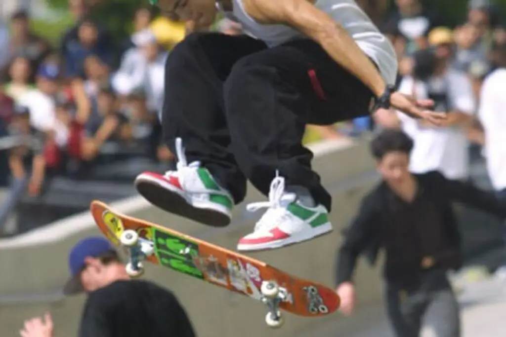 Image of a skateboarder doing a skateboard trick.