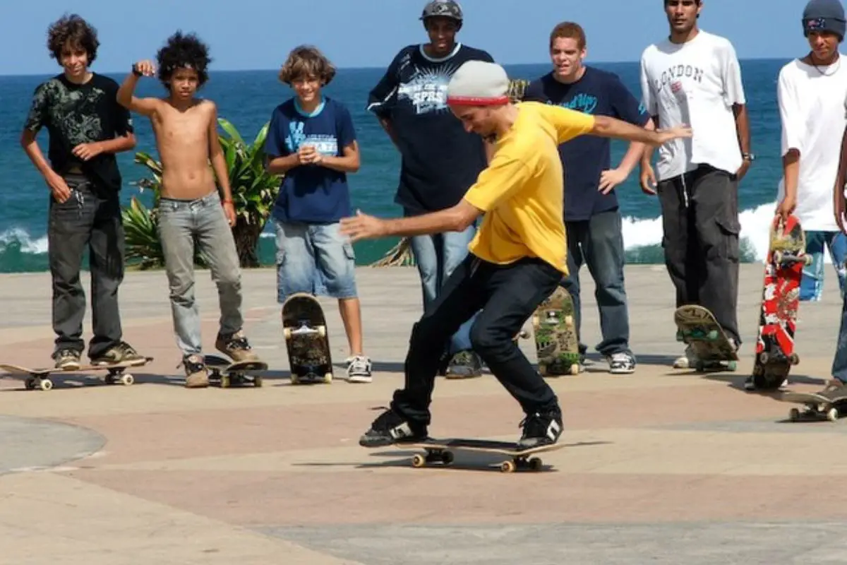 Image of a skateboarder skating in front of other skaters.
