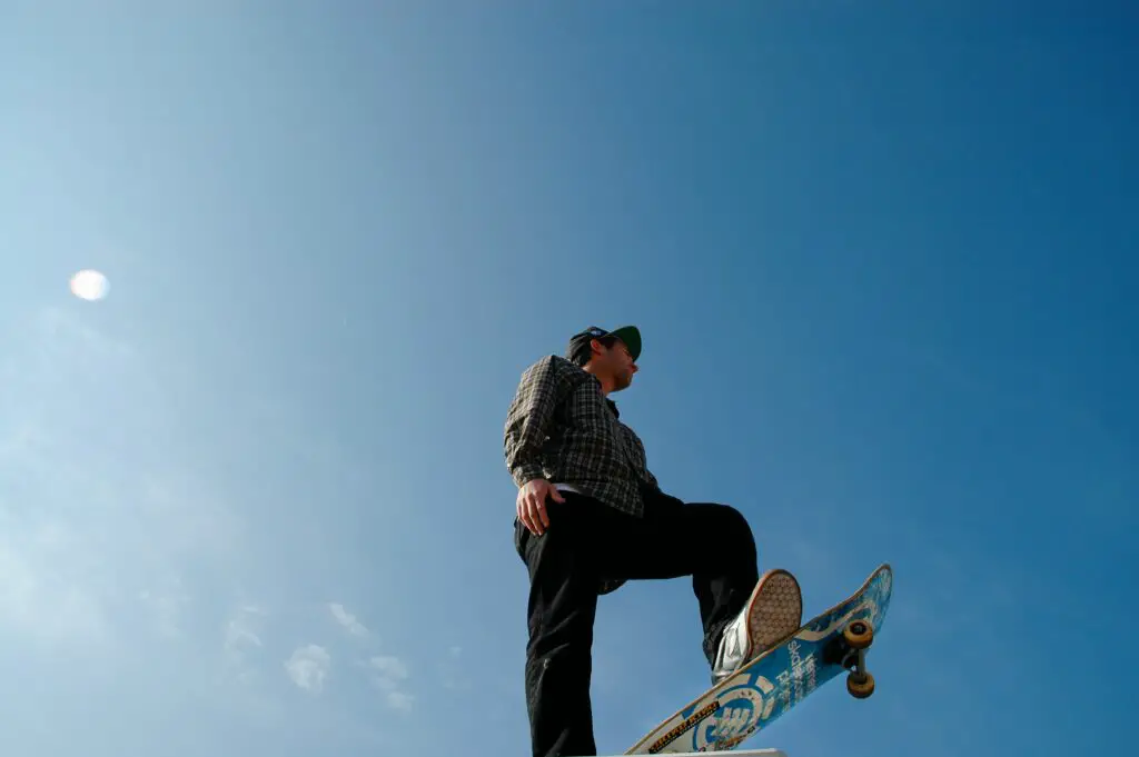 Image of a skateboarder with the sky as the backdrop.