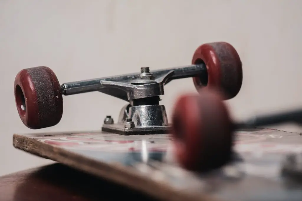 Image of an upside down skateboard showing its wheels and trucks.