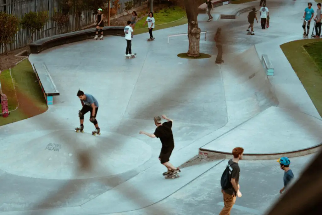 Image of skateboarders skating in a skate park.