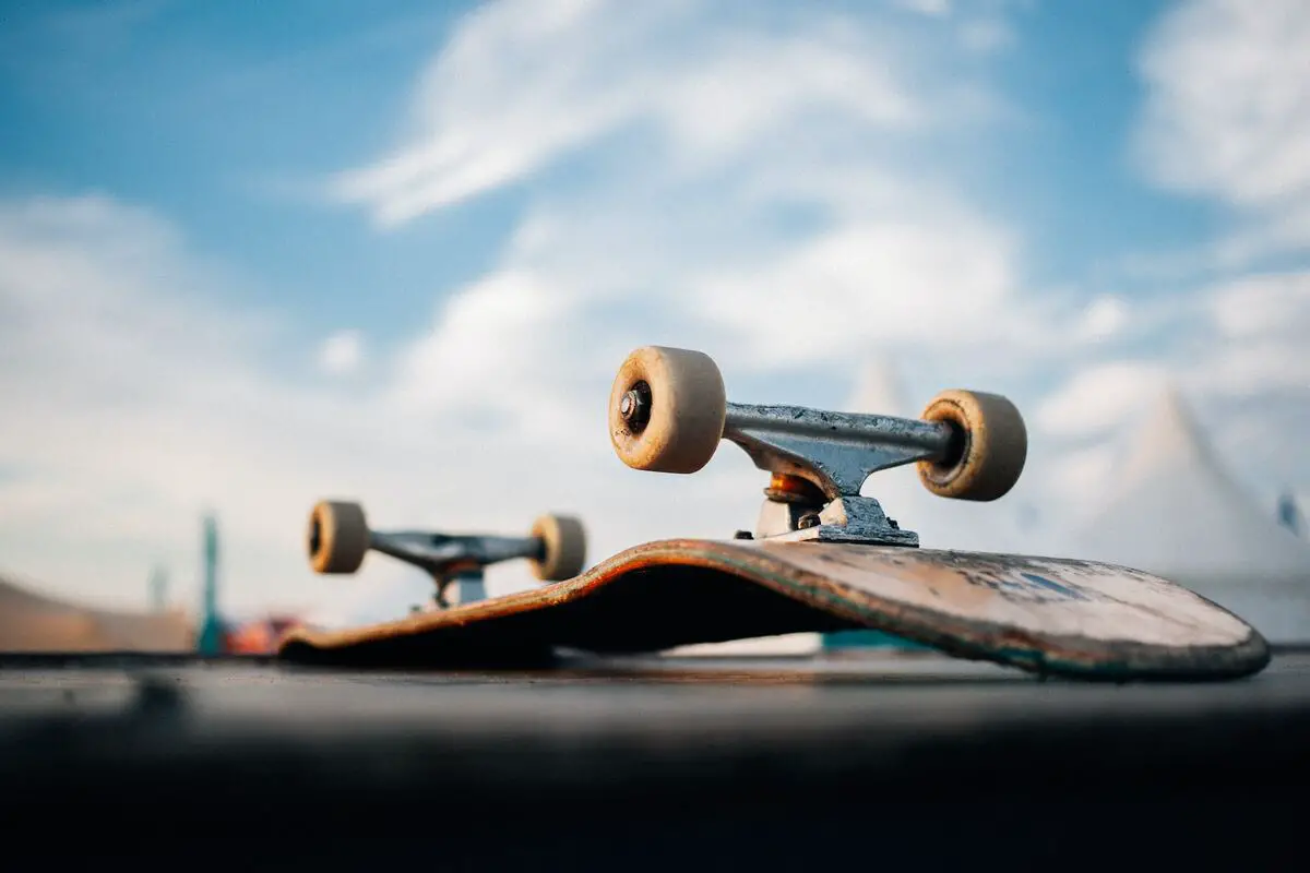 Image of a flipped skateboard on concrete floor. Source unsplash