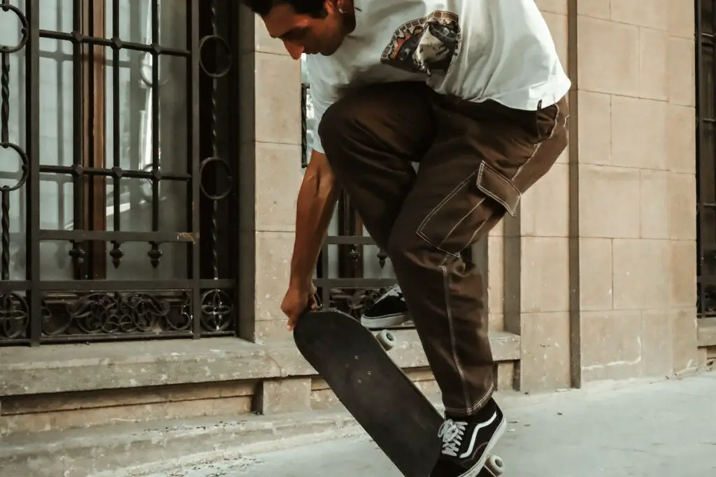Image of a man doing a skateboard trick midair. Source: pexels