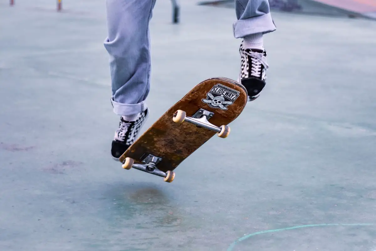 Image of a person riding skateboard on a concrete surface. Source: unsplash