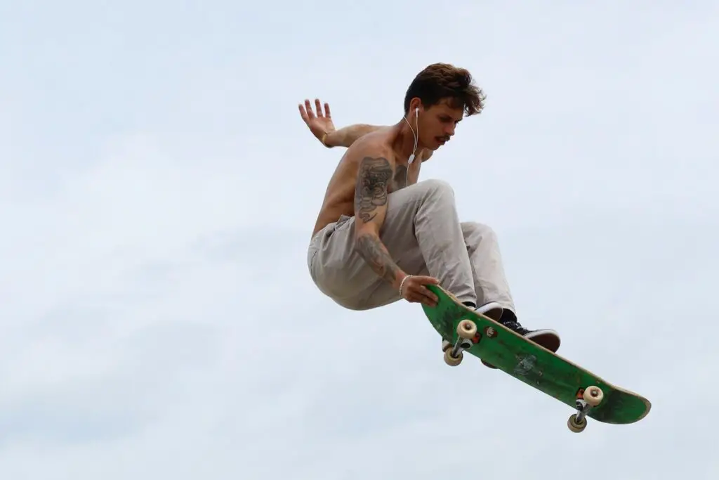 Image of a skater doing tricks on a skateboard with headphones on. Source: unsplash