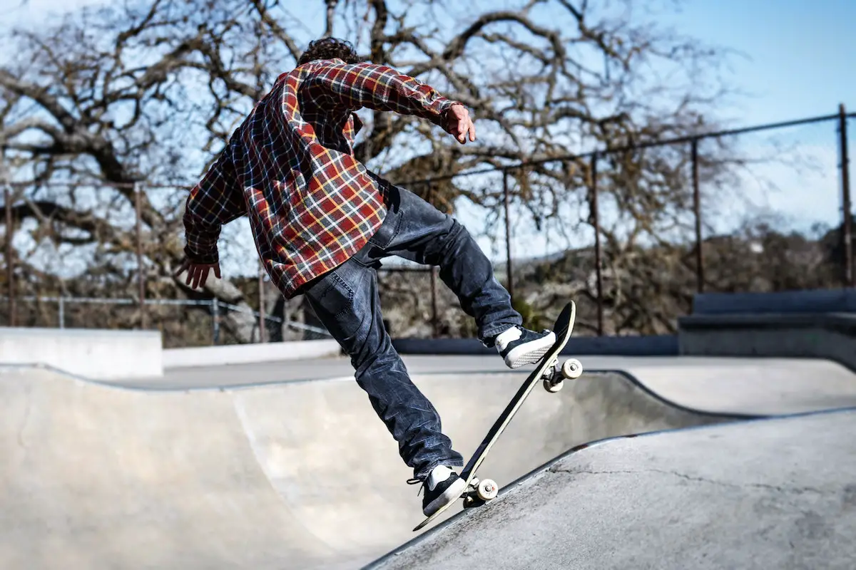 Image of a skater practicing a skateboard trick in a skatepark. Source: pexels