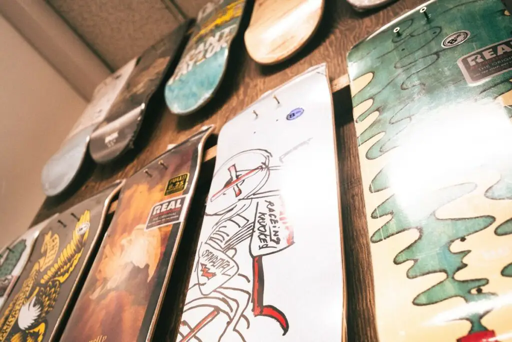 Image of skateboards hanging on a wall of a local skate shop. Source: unsplash