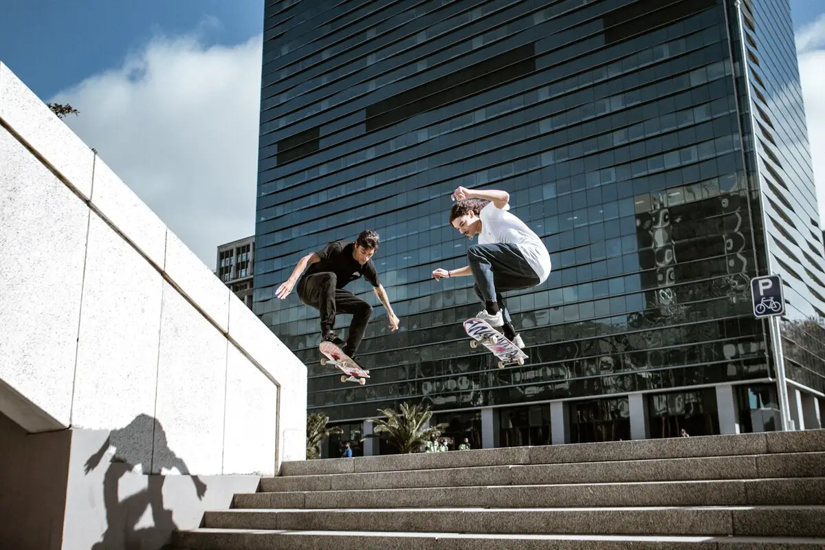 Image of two skaters jumping down a flight of stairs. Source: unsplash