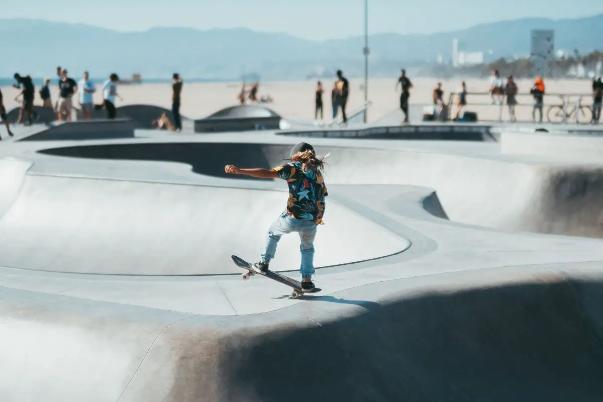 Image of a young boy skateboarding in a skate park during daytime. Source: unsplash