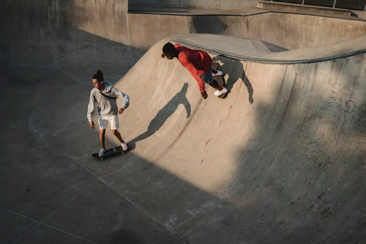 Image of skateboarders practicing skateboarding in a skate park. Source: pexels