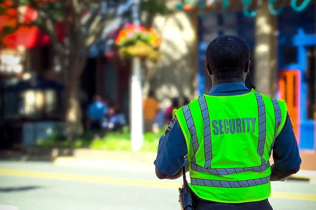 Image of a security guard standing in the streets. Source: unsplash