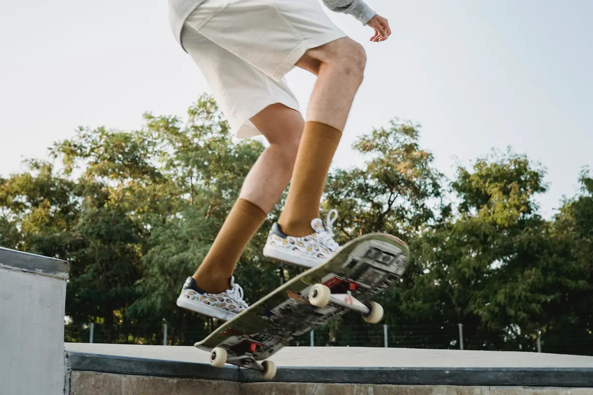 Image of a skater doing a trick in a park. Source: pexels