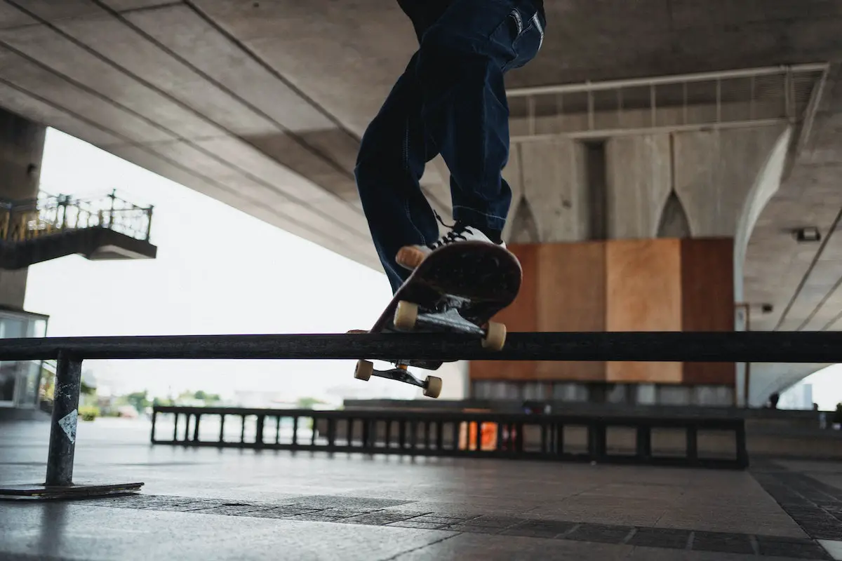 Image of a skater performing a trick on a rail. Source: pexels