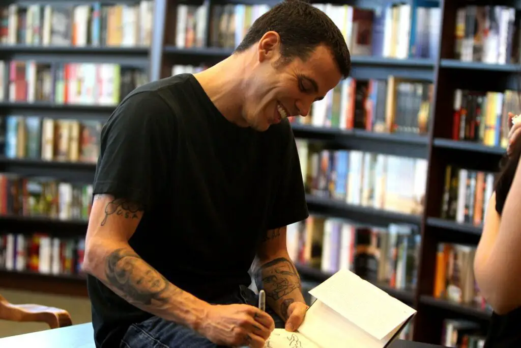 Image of steve-o signing a book for a fan. Source: wiki commons