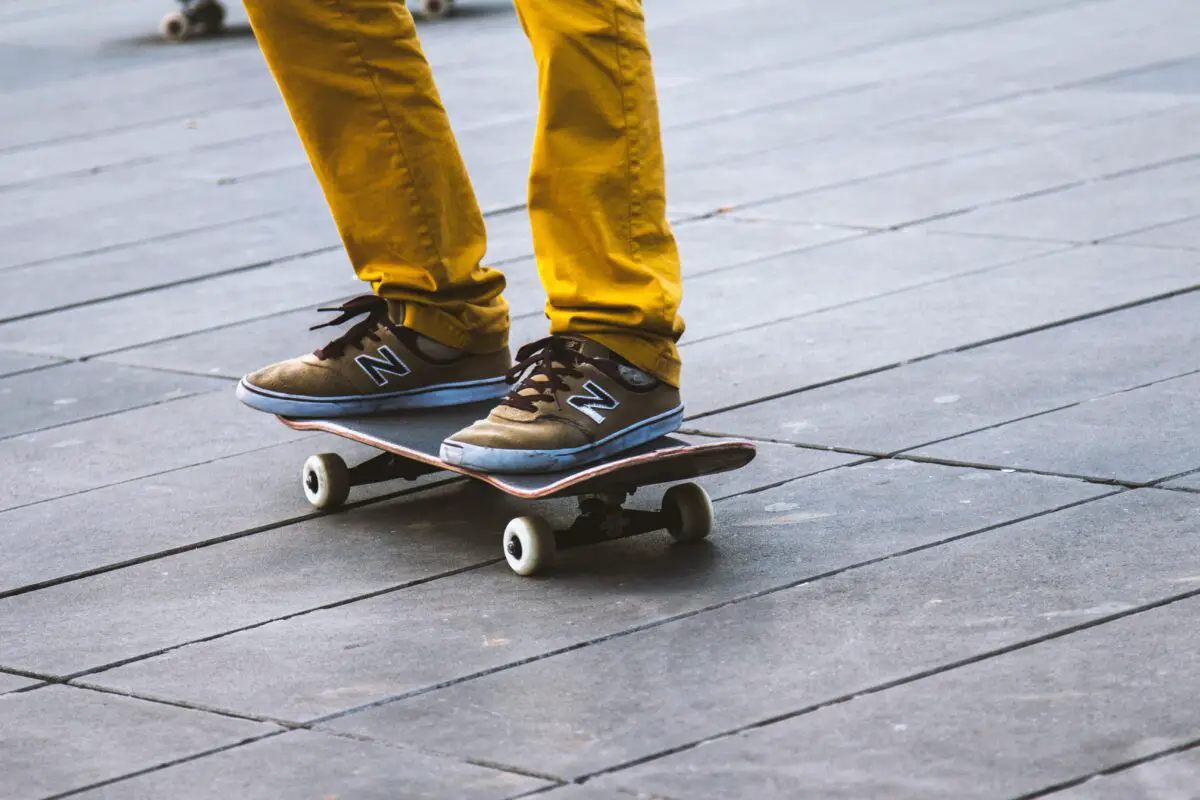 Image of a person wearing yellow pants standing on a skateboard. Source: unsplash