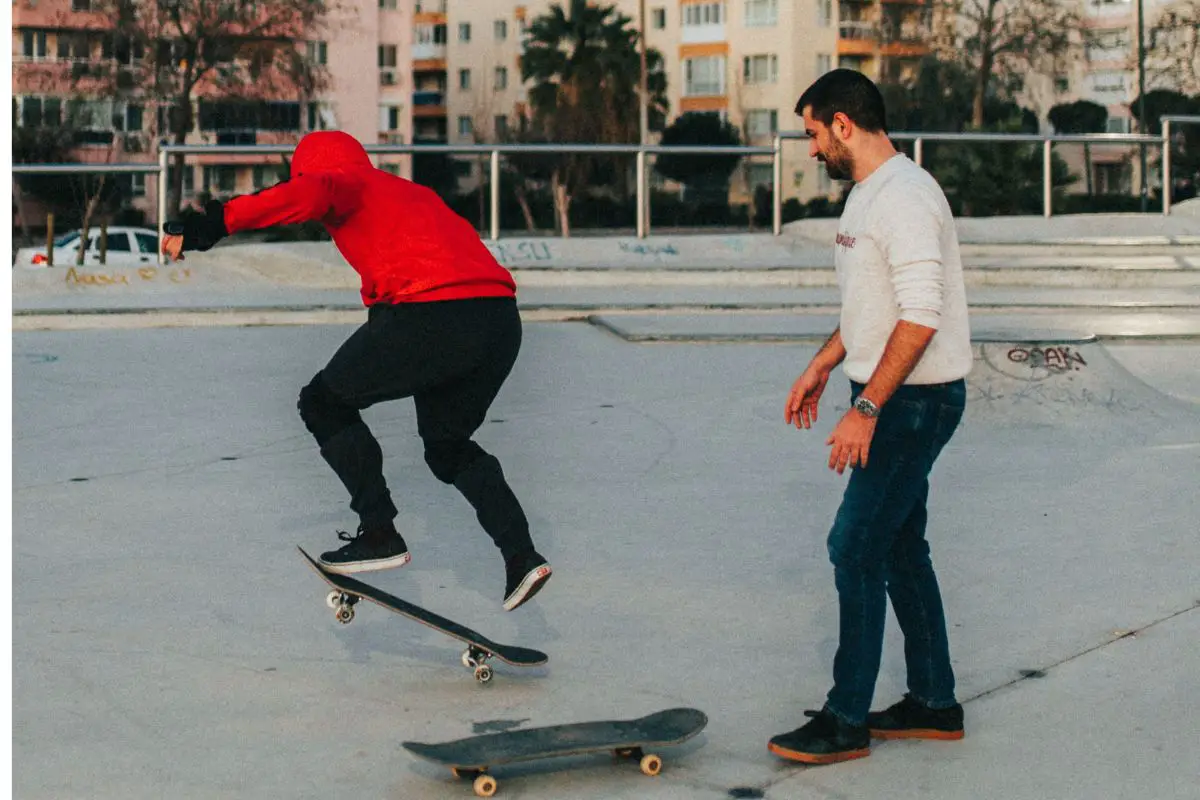 Image of two men riding on black skateboard during daytime. Source: unsplash