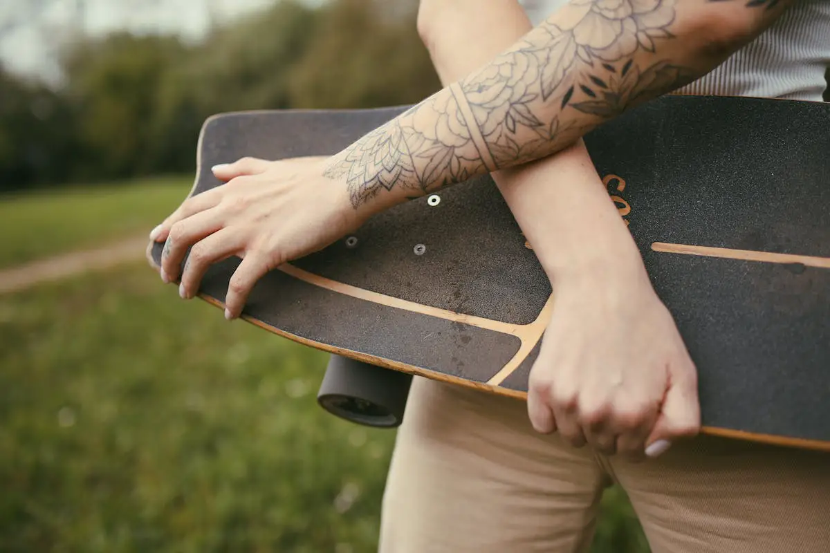 Image of a person holding a skateboard. Source: unsplash